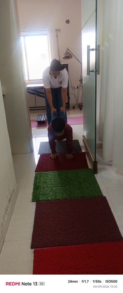 Therapist supporting a child during therapy at Divine Rehab Care, Silvassa